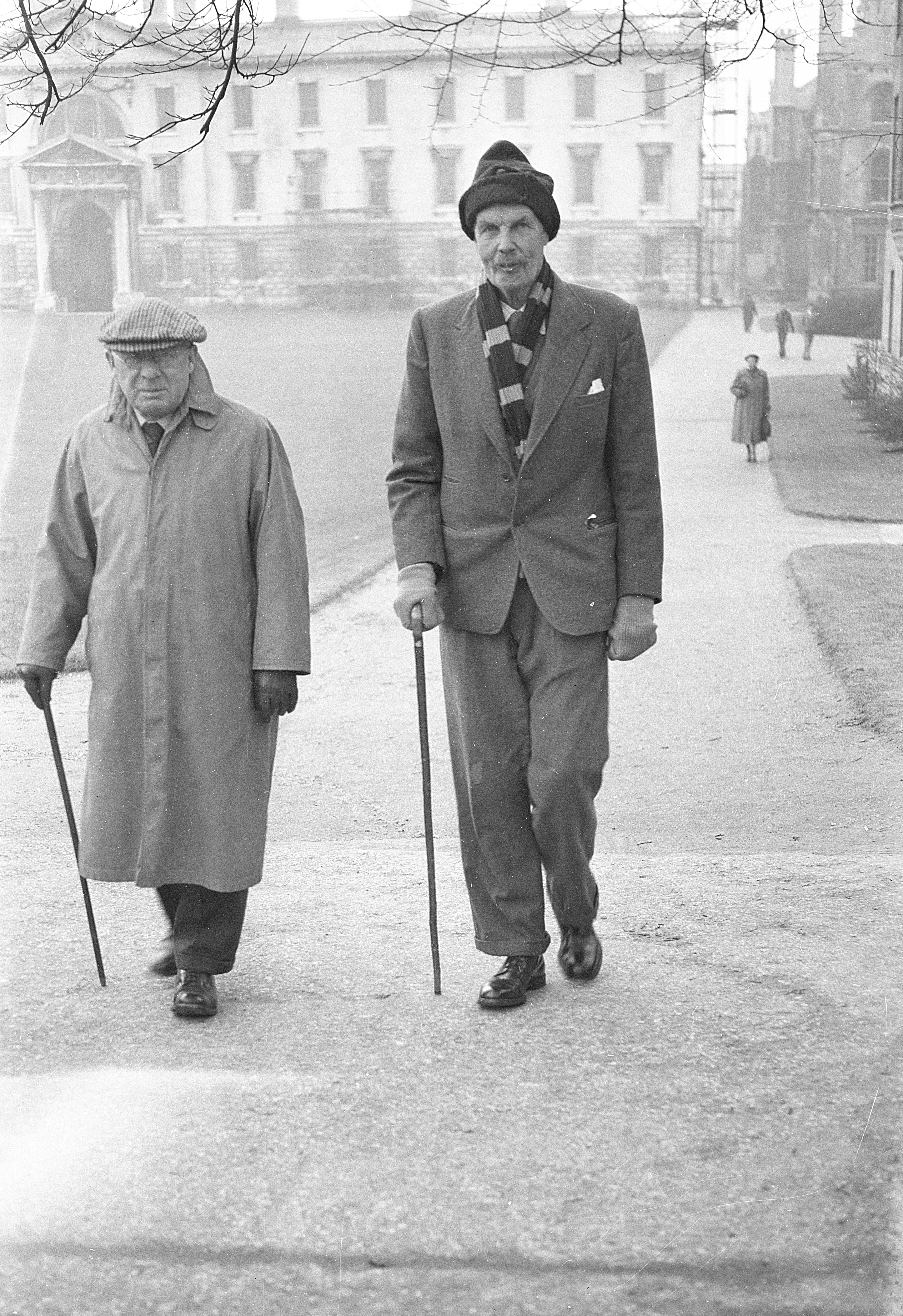Arthur Pigou and Frank Adcock on their regular walk, with the Gibbs building in the background, taken by © Richard Cormack, c. 1952-55